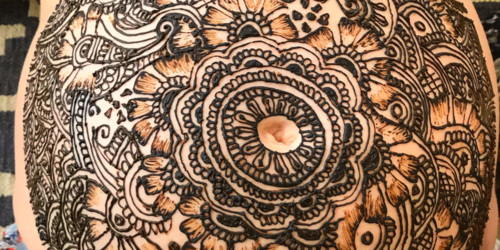 Henna designs on the belly of a pregnant woman